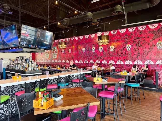 High-energy bar with vivid mural and colorful seating