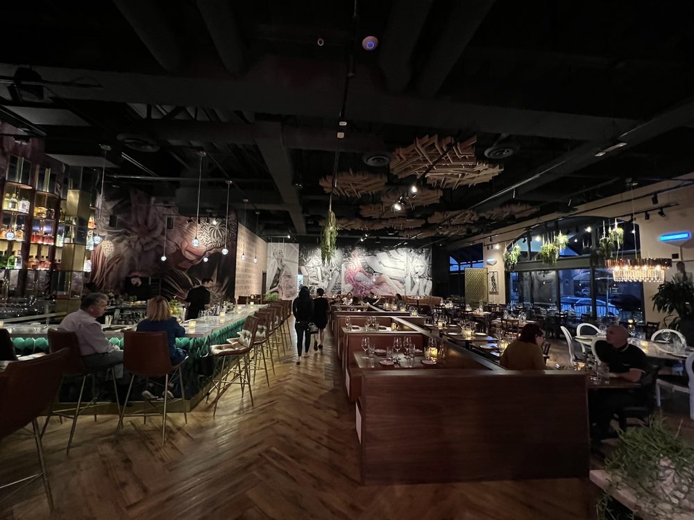 Full restaurant dining room with custom booths, murals, and lighting by Lion Craft