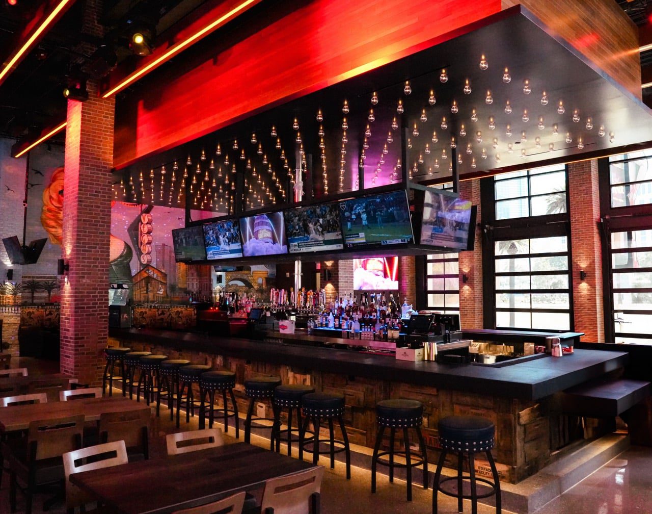 Reclaimed-wood bar and light canopy at Bottled Blonde Las Vegas by Lion Craft